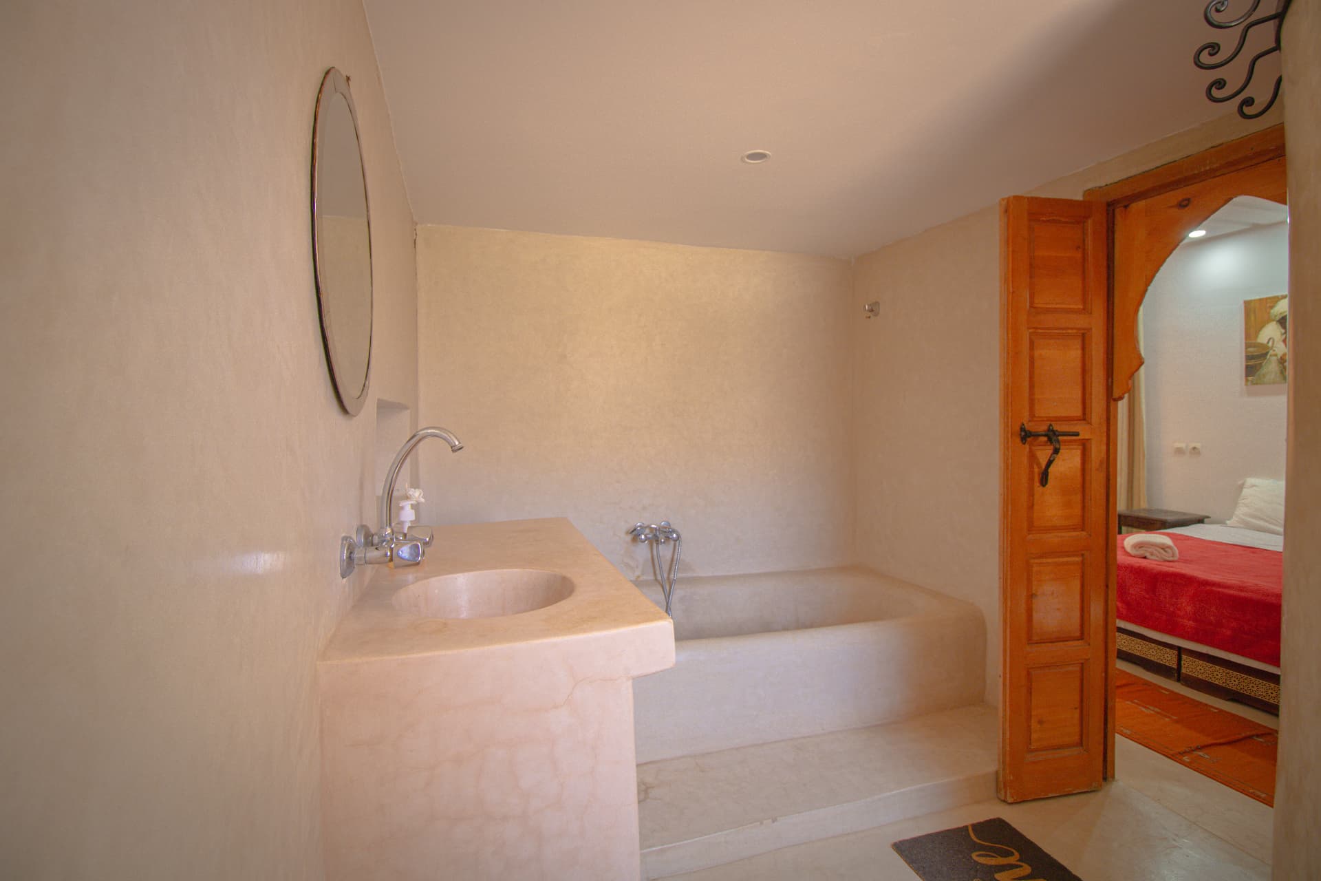 ATLAS — tadelakt bathroom with carved sink and bath