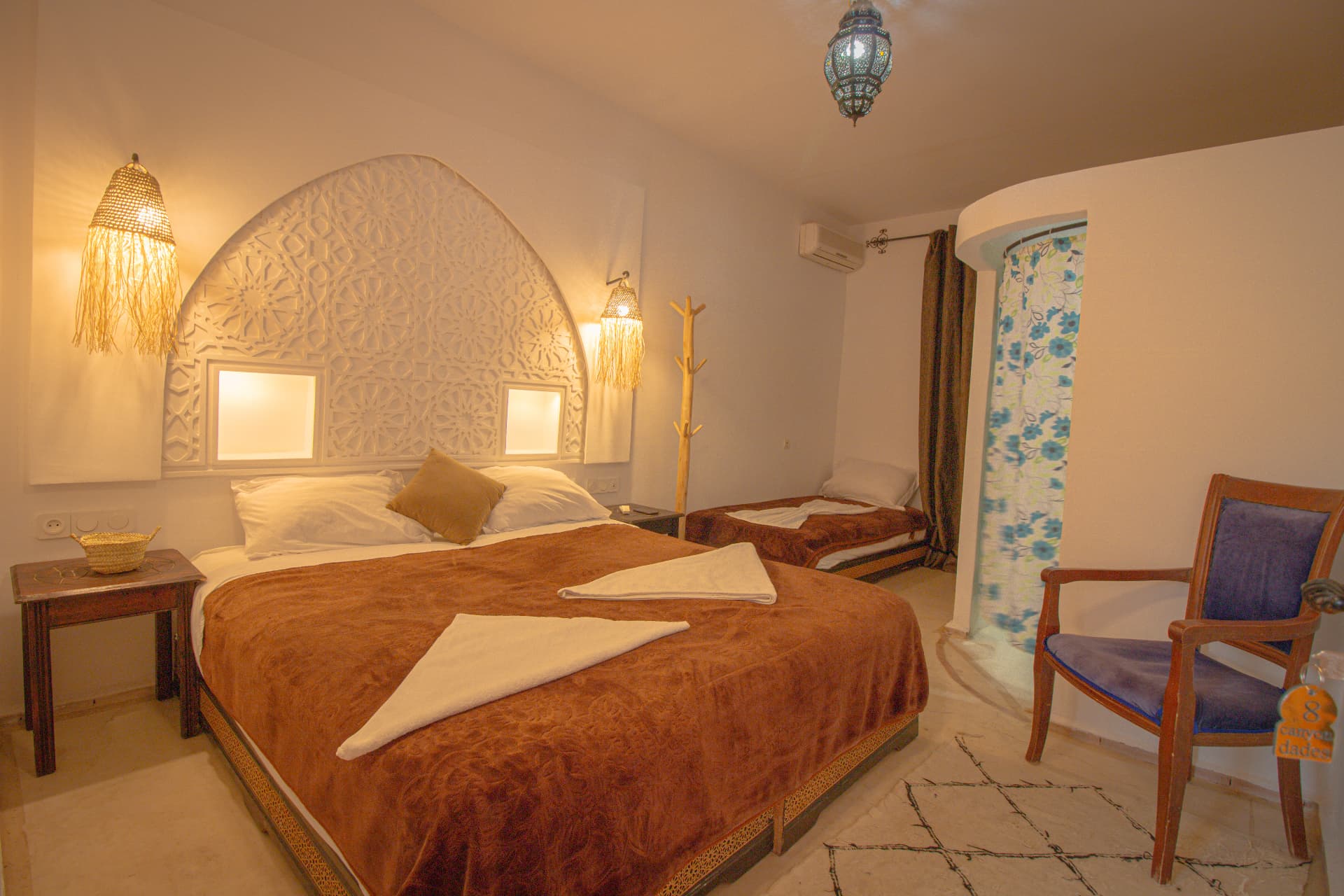 ANYA — wide bedroom with carved arch headboard, double and single bed