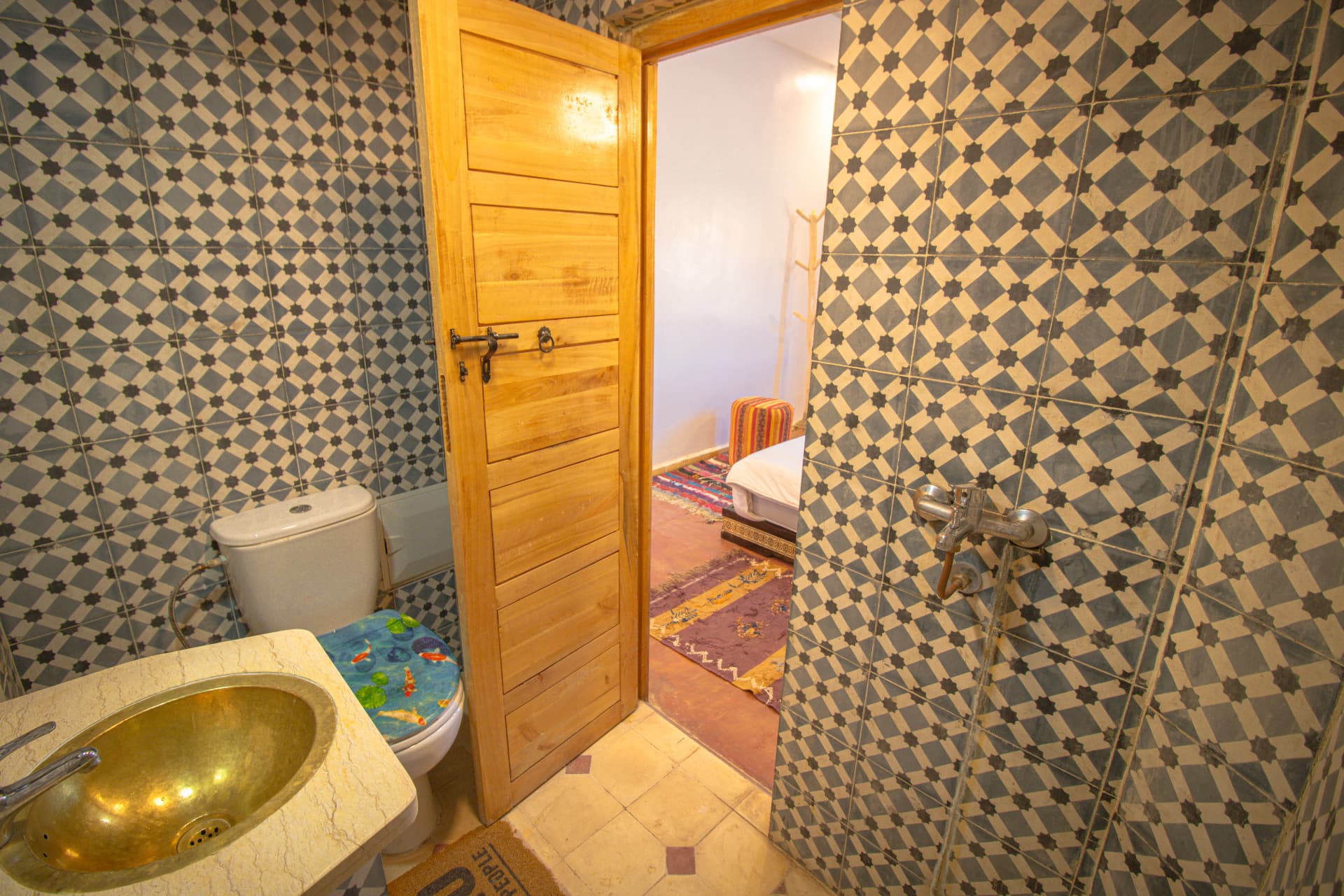 TODRA — bathroom in star-patterned zellige with brass basin and walk-in shower