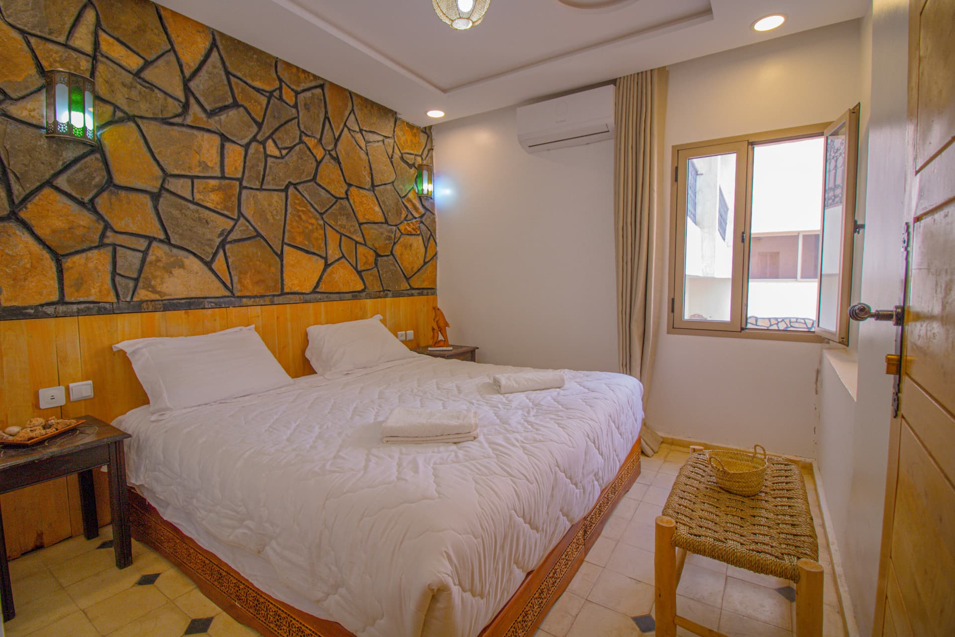 TAFUKTE — second bedroom with open window and carved bed
