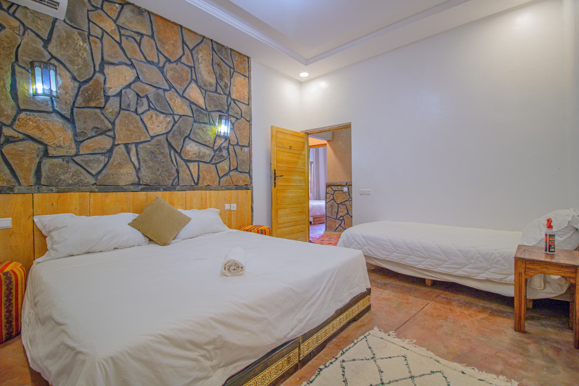 ZAGORA — wide triple room view with stone feature wall, double bed and single bed