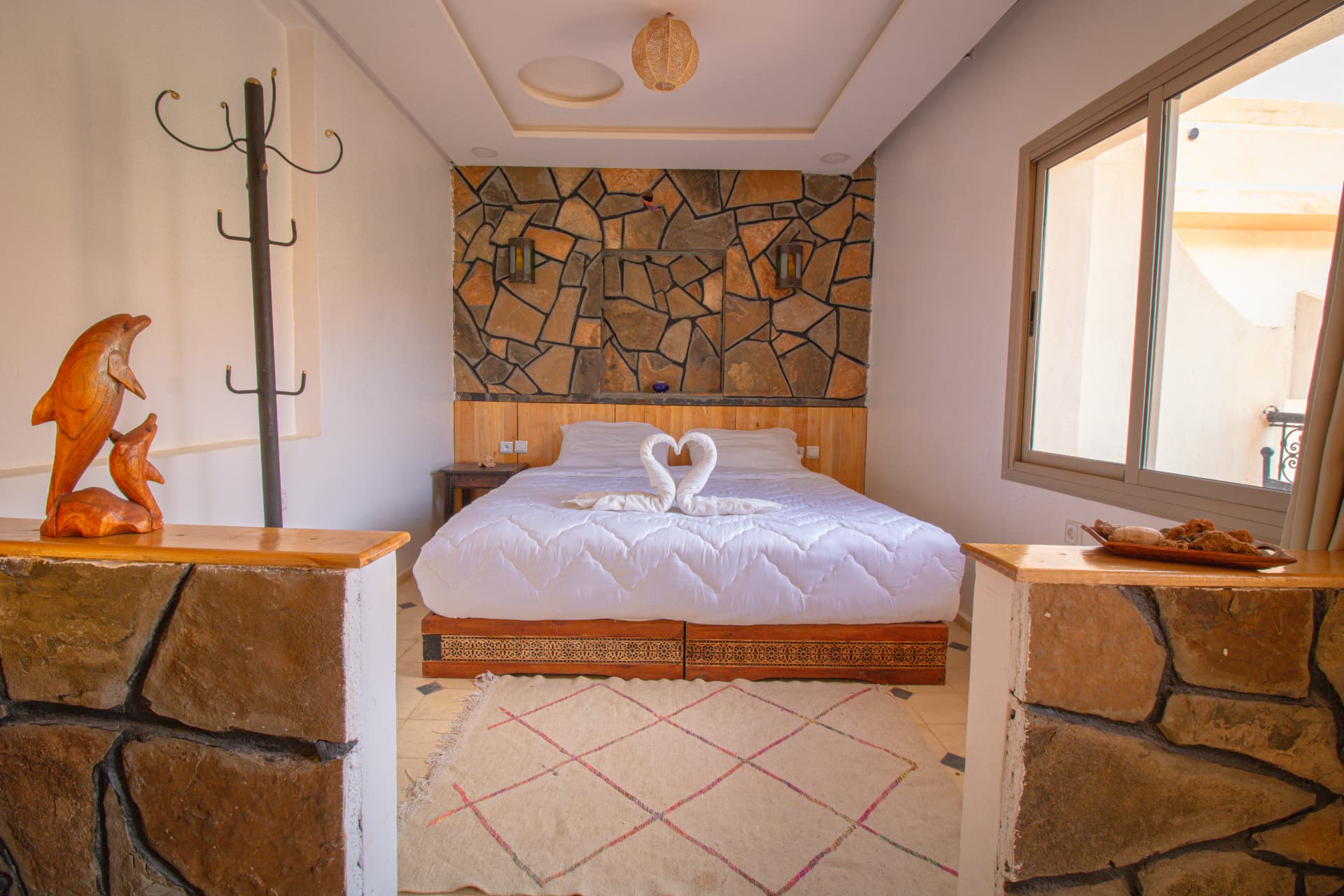 TAFUKTE — full view of the suite with stone wall and window
