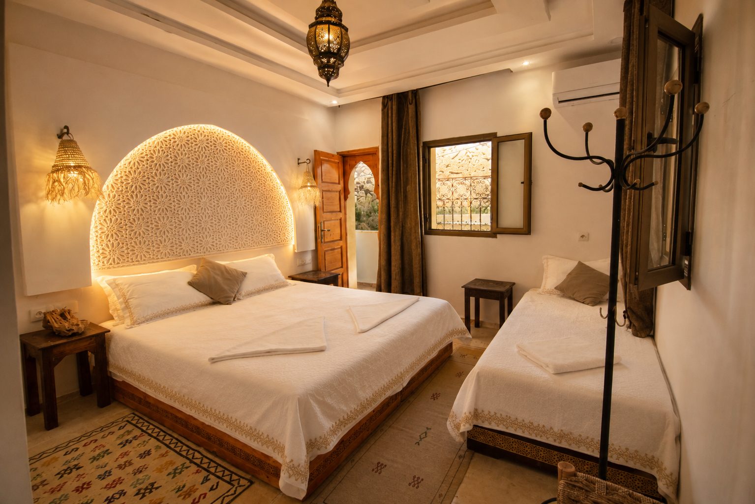 AMENTI — wide bedroom with carved arch headboard, double and single bed