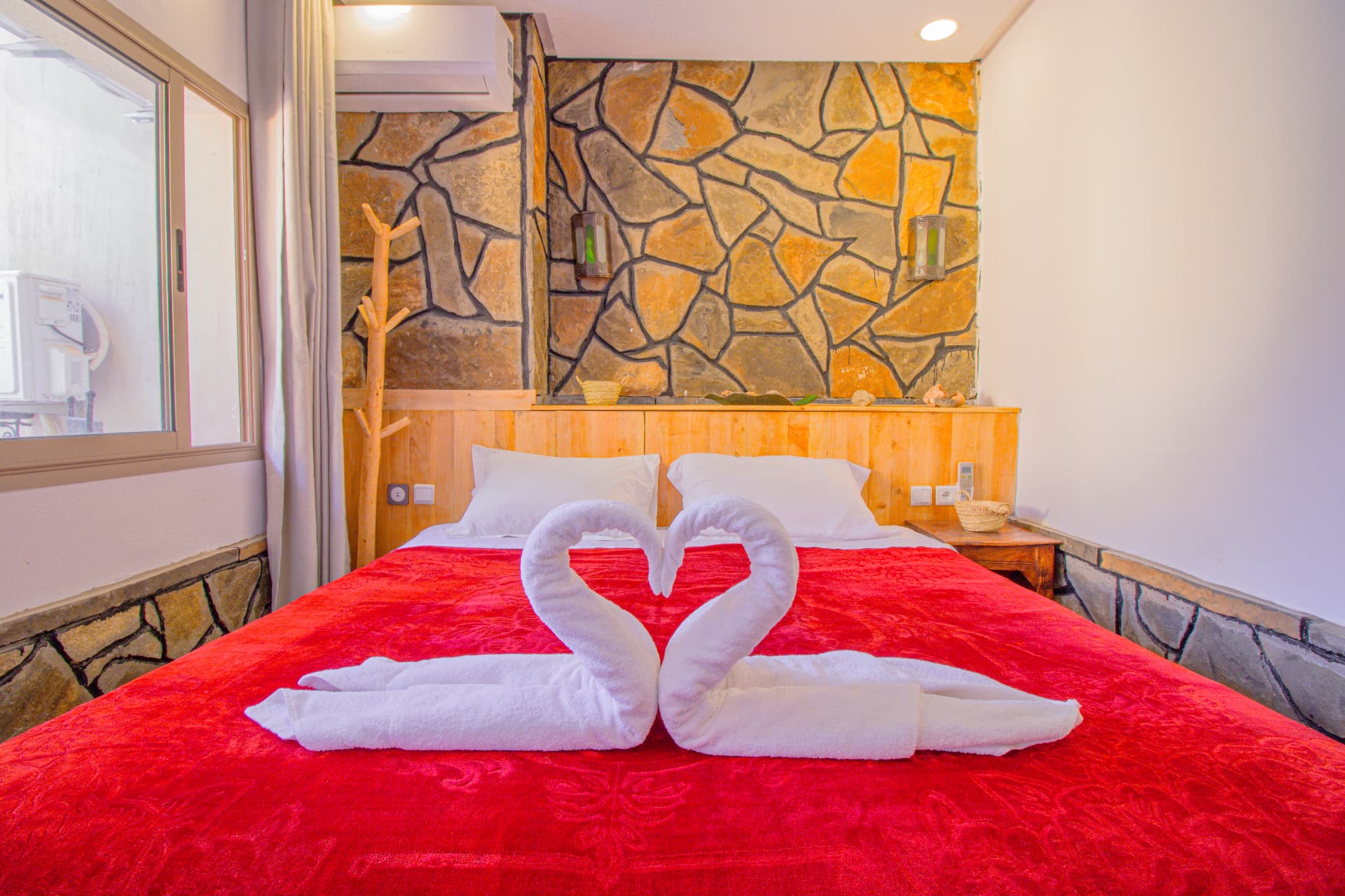 Room with stone feature wall and towel swans