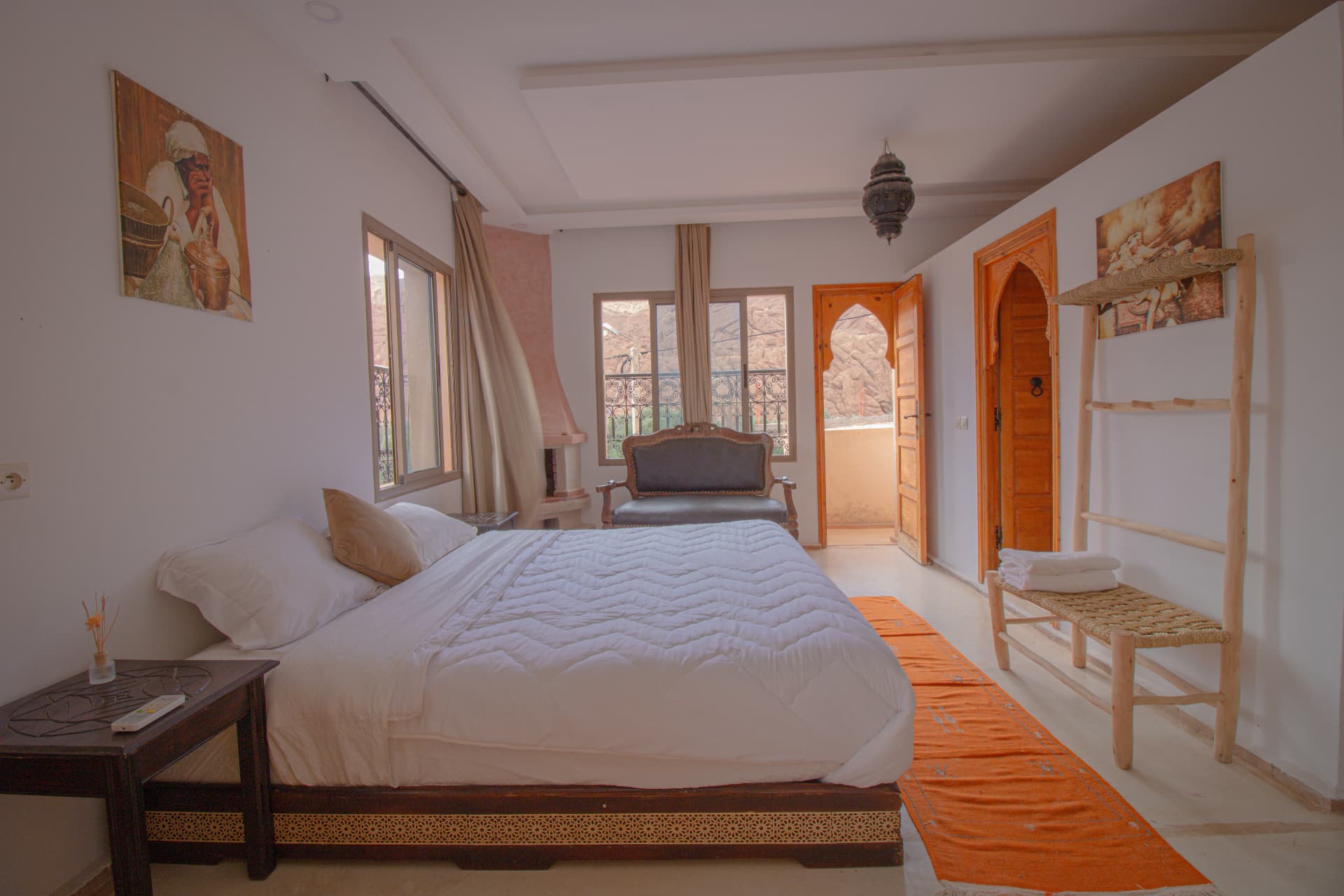 ATLAS — bedroom detail with ladder towel rack and balcony door