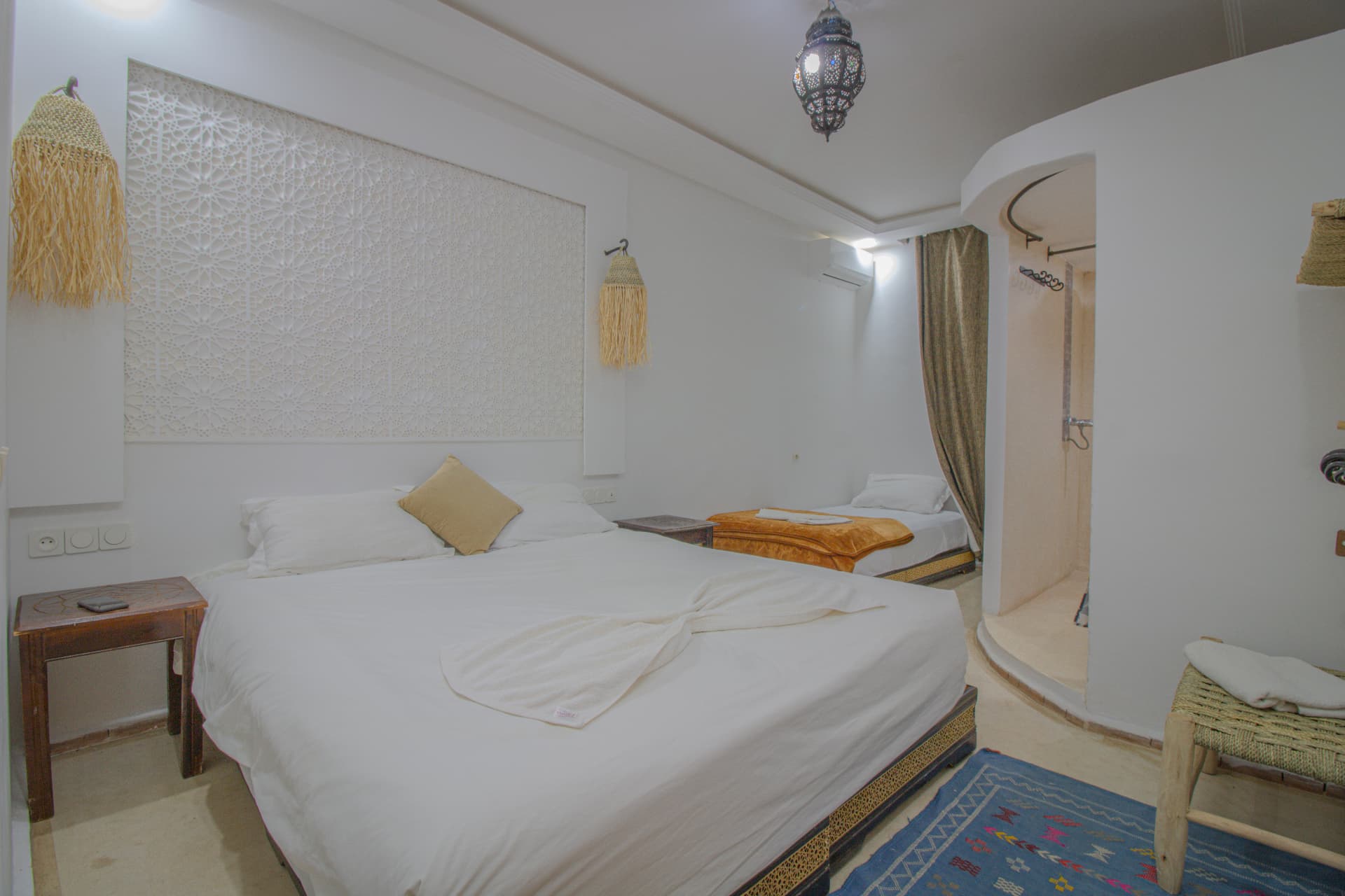 AFRI — bedroom in daylight with carved headboard panel and lantern