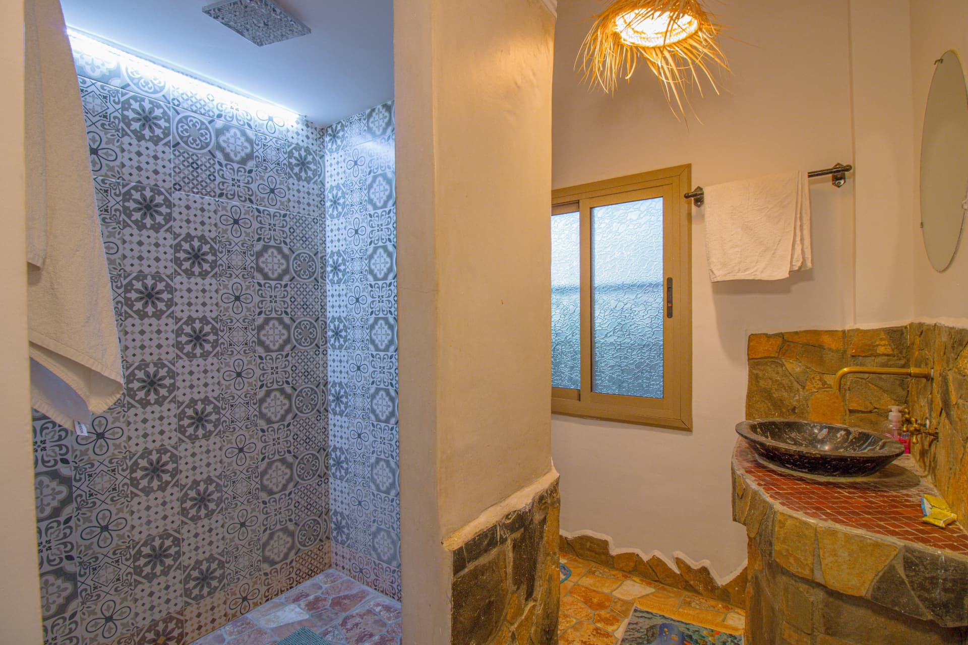 AYOUR — bathroom with patterned zellige shower and stone basin
