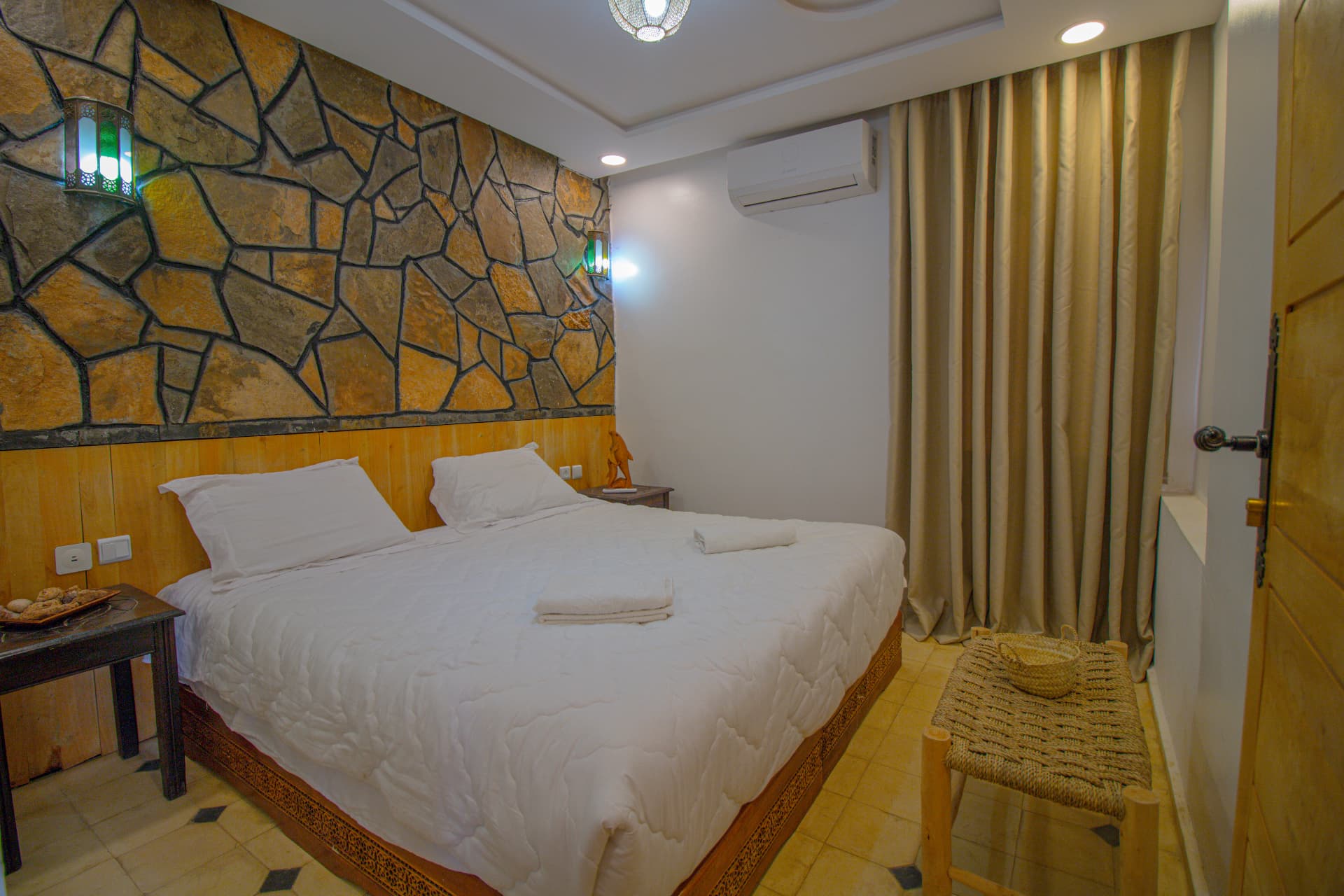TAFUKTE — bedroom detail with lantern light and curtains