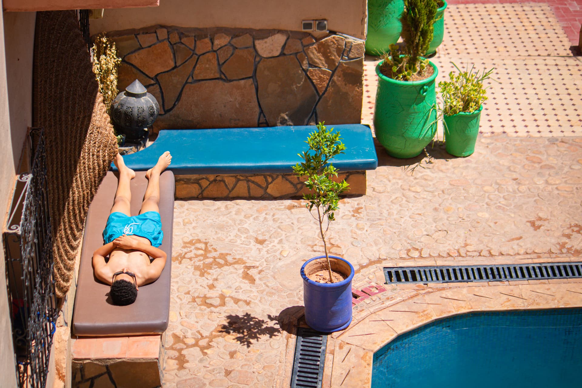 Pool deck with sun loungers in the riad courtyard