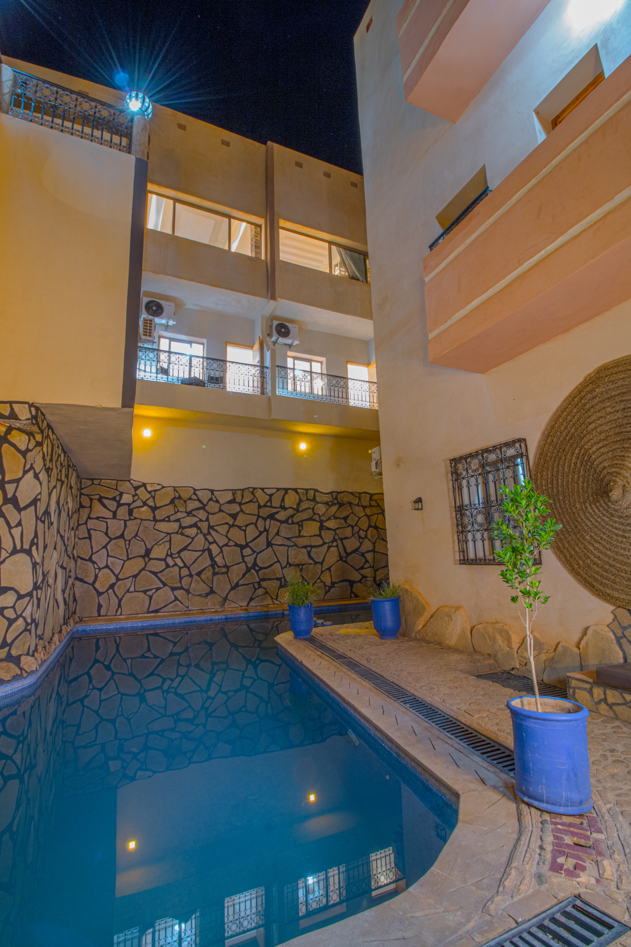 Night reflections on the courtyard pool beneath the balconies of Riad Canyon Dades